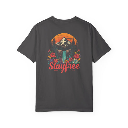 Black t-shirt with a mountain and floral design on the back, featuring the word 'Stayfree'.